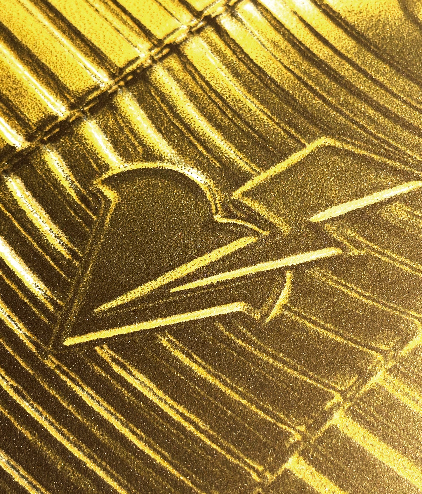 Close-up of a gold pointilism with Marwan Shahin logo.