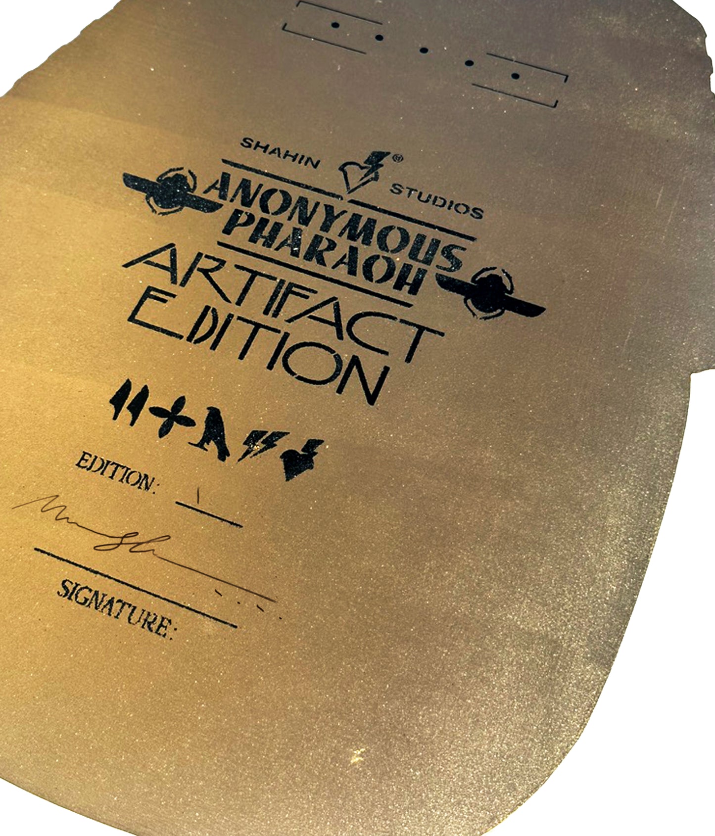 Gold artifact with 'Anonymous Pharaoh' branding and text